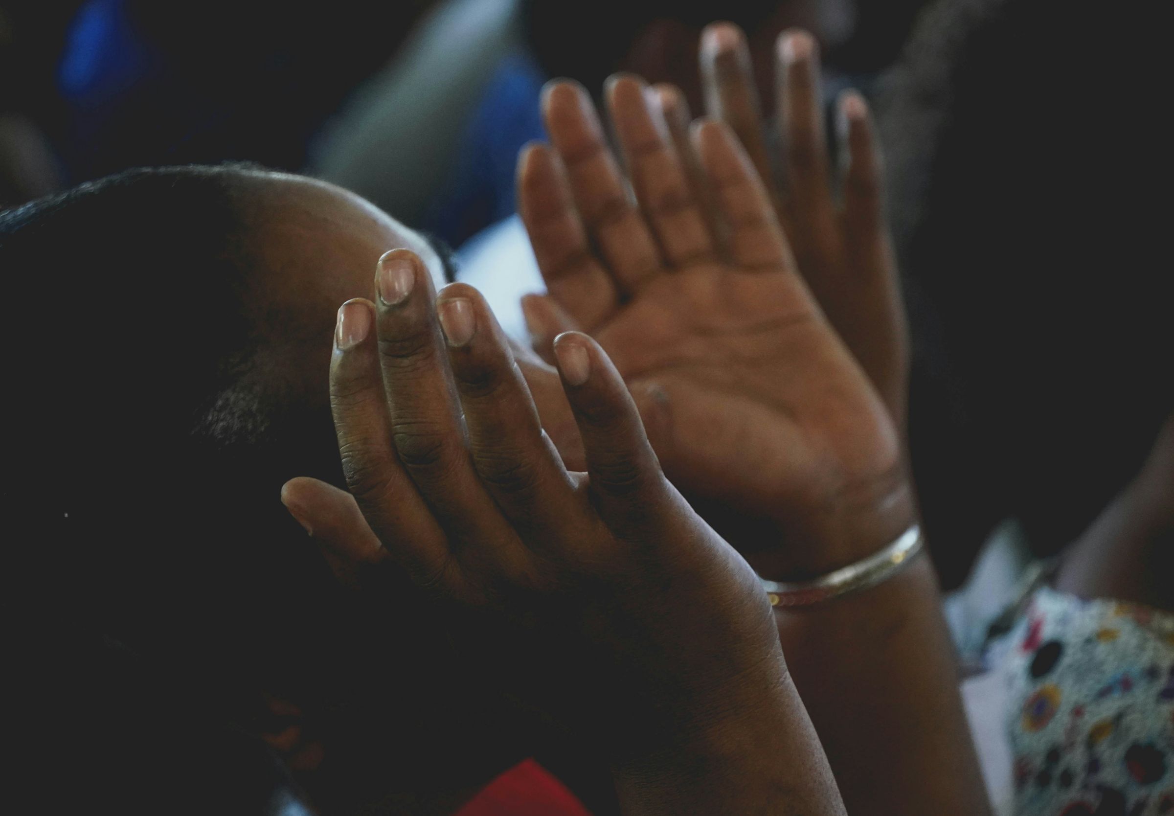 Hands raised in prayer during worship