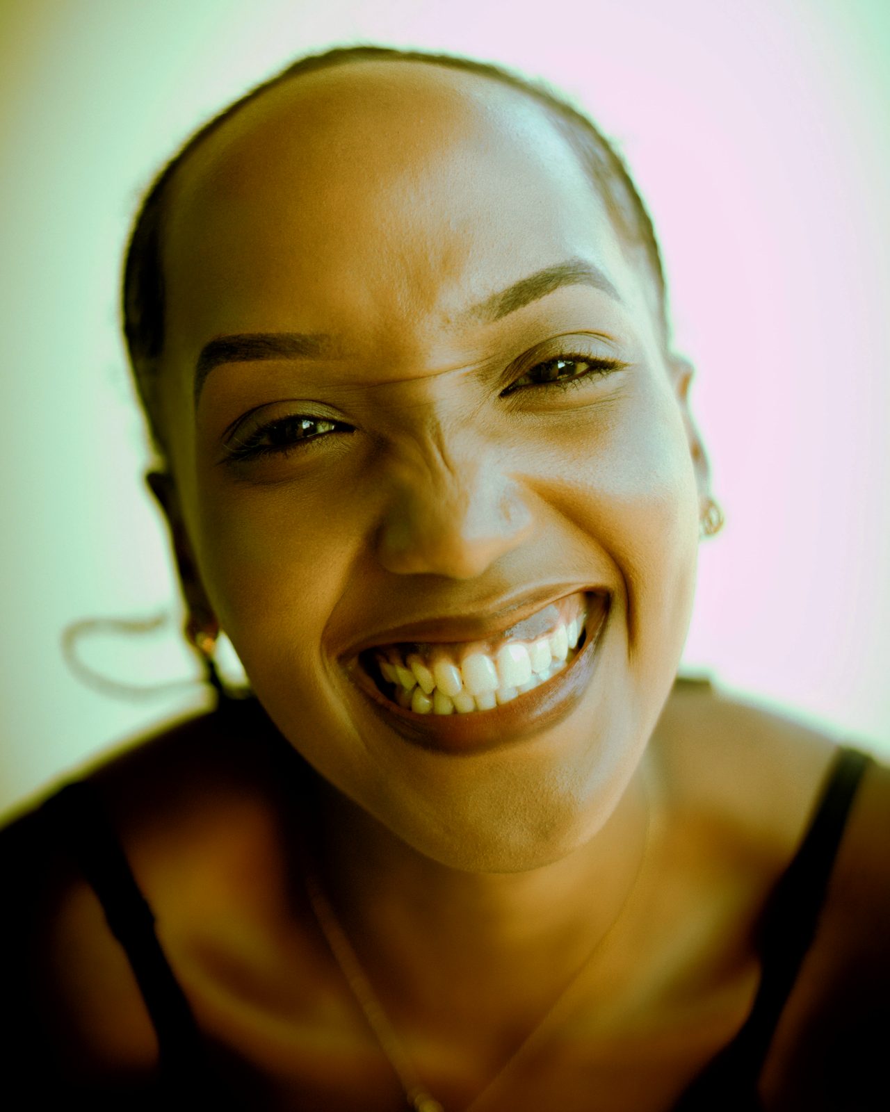 A woman laughing with a huge smile